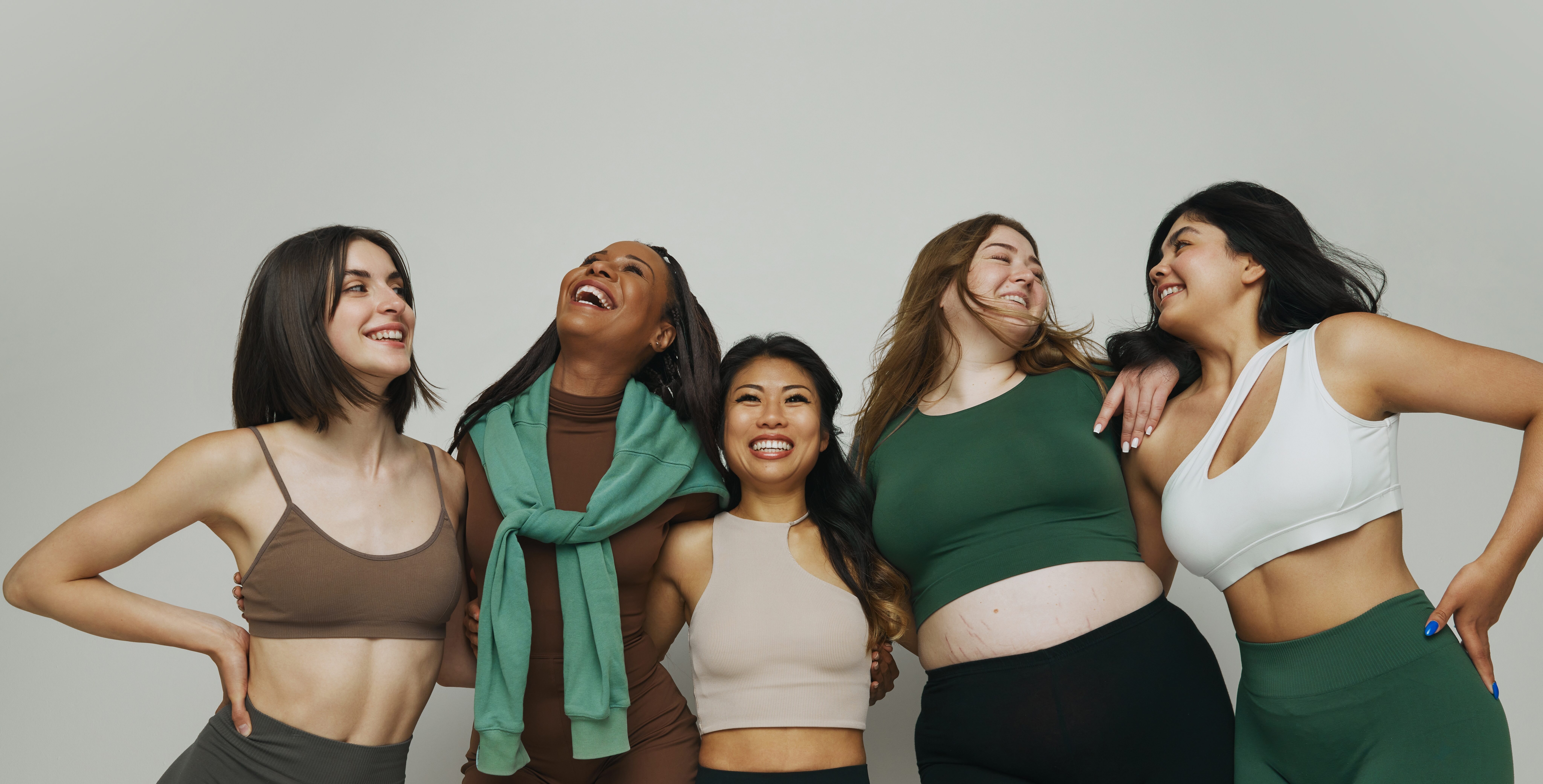 Happy,Smiling,Diverse,Women,,Each,Wearing,Trendy,Athletic,Clothing,Posing