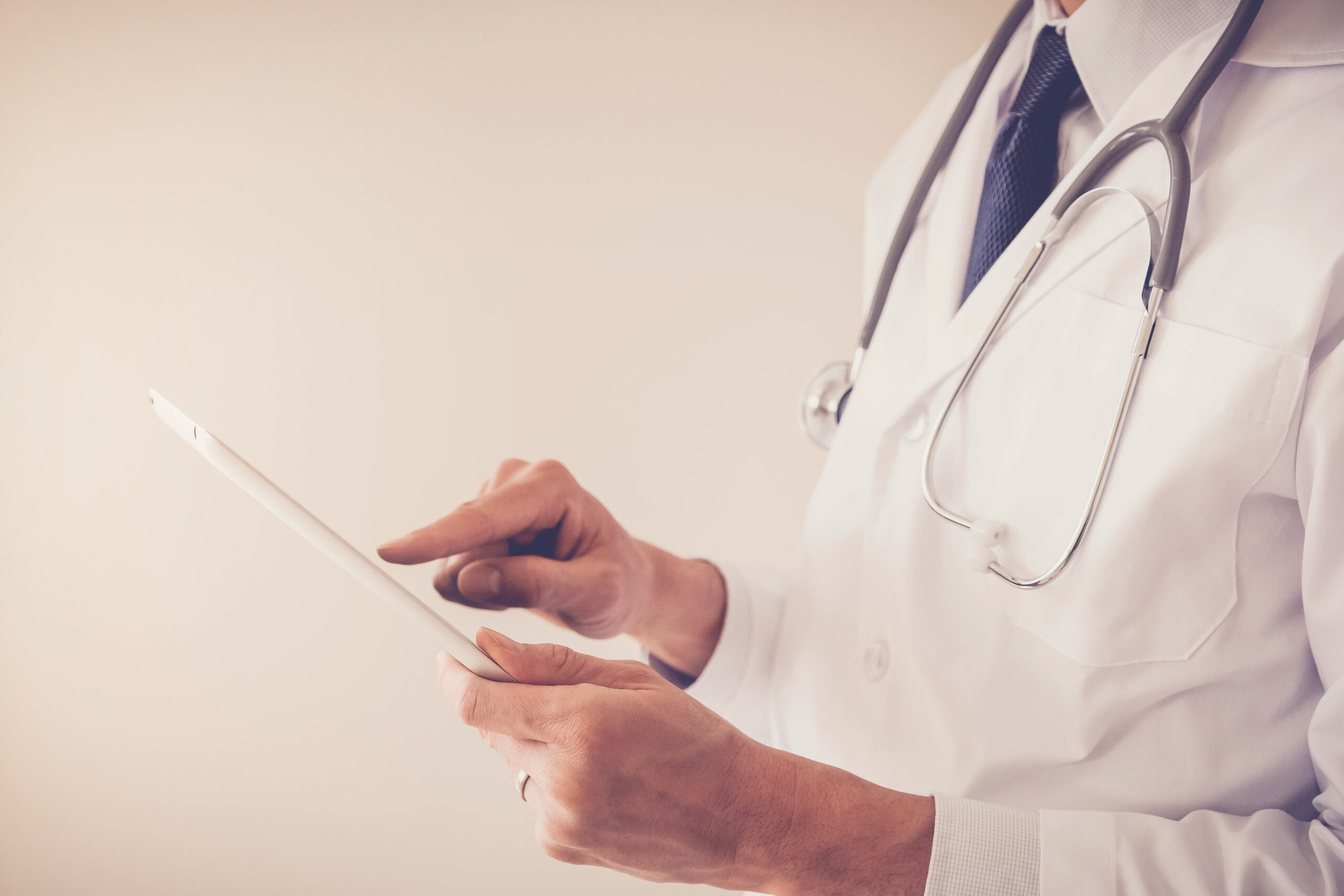 Medical,Doctor,Hands,Holding,Tablet,,Using,App,Working,Remotely,,Telehealth,