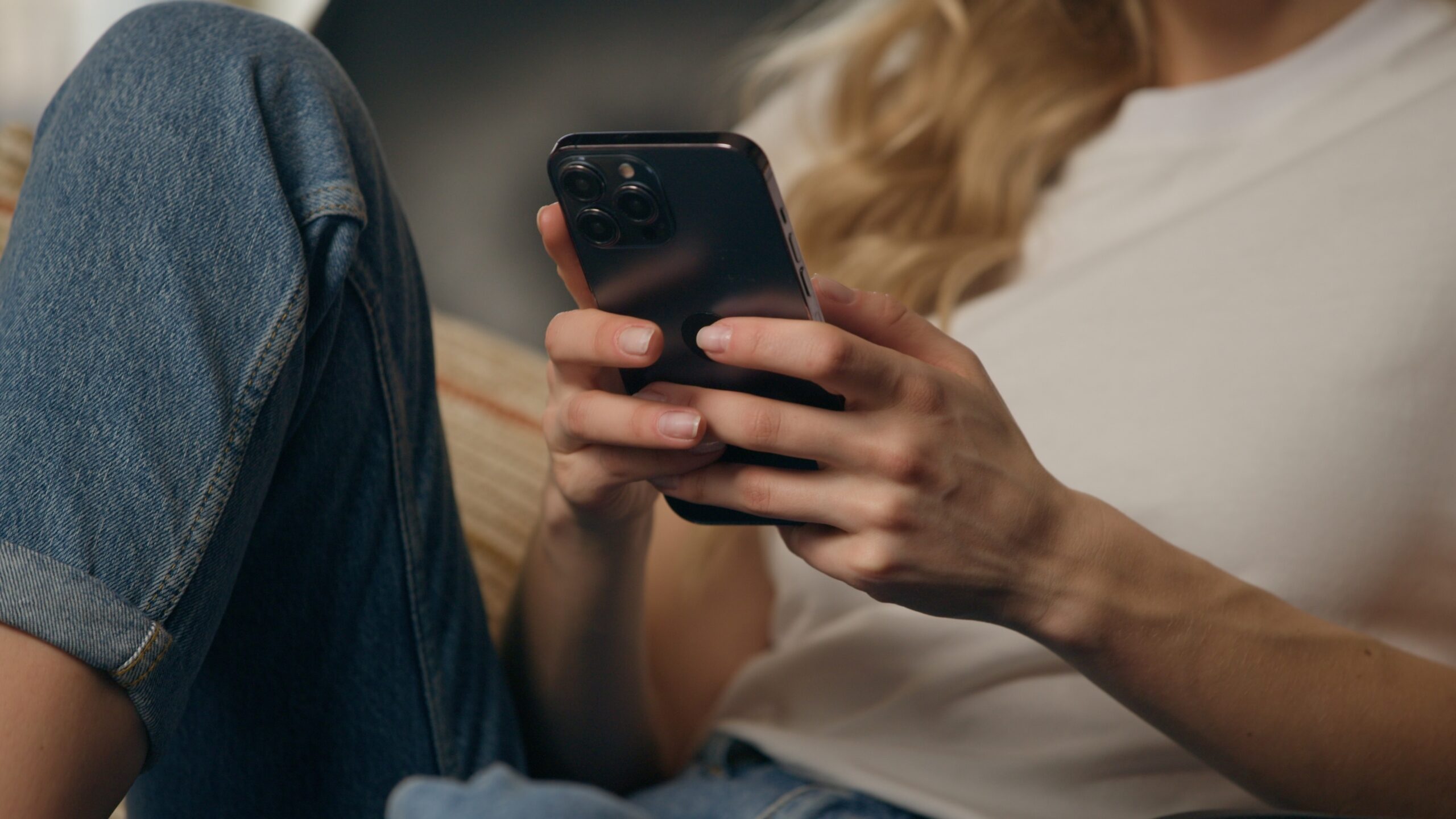 Close,Up,Smiling,Woman,Client,Browsing,Mobile,Phone,At,Home